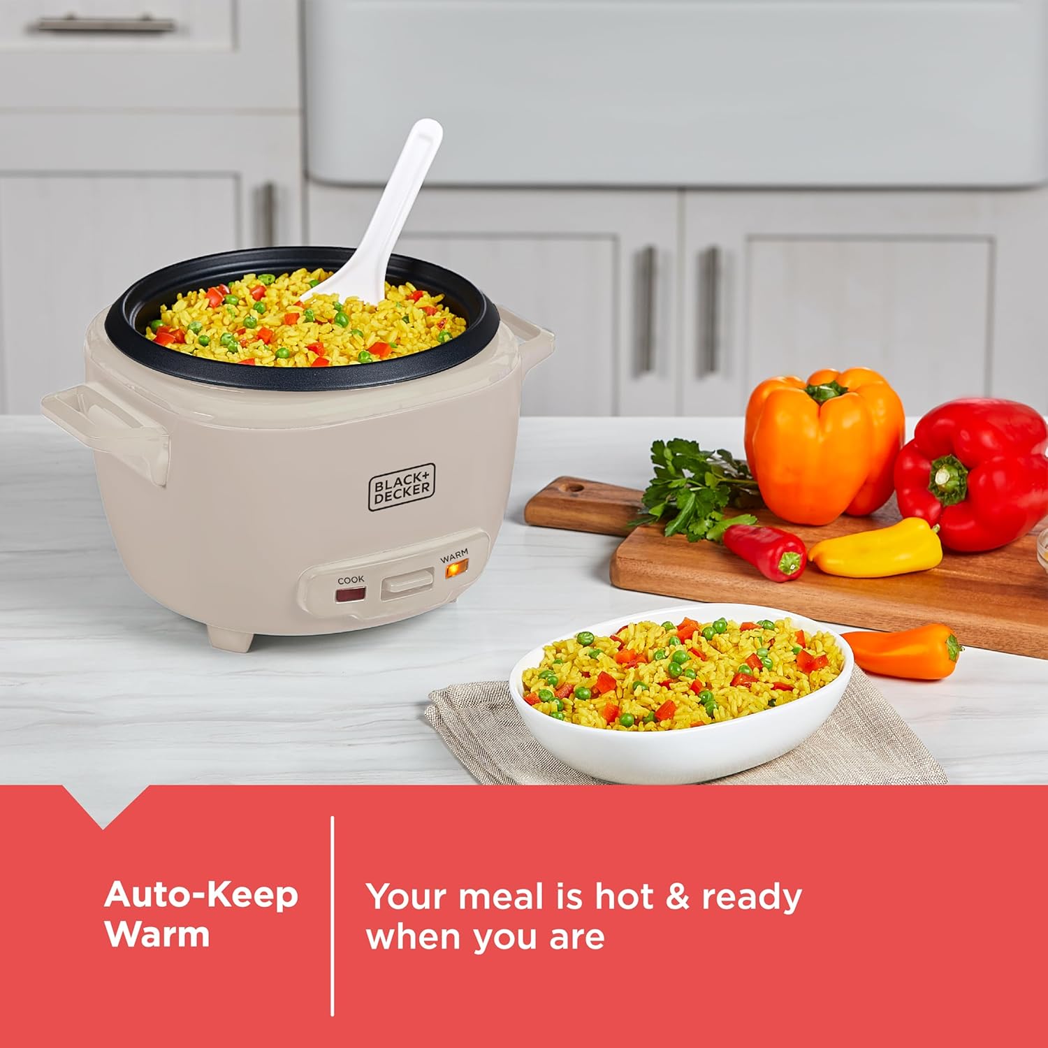Black & Decker rice cooker with cooked rice and vegetables on a kitchen counter