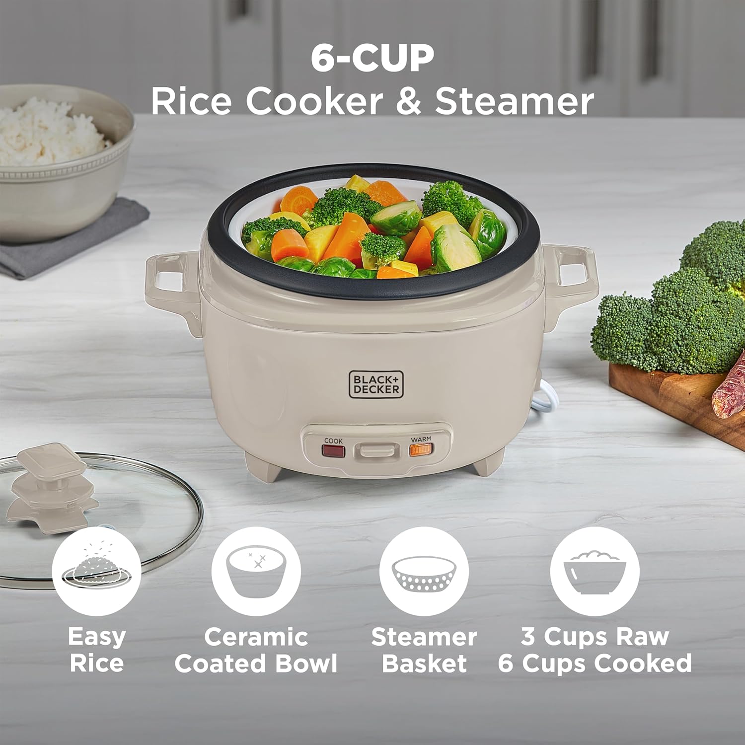 Beige rice cooker with steamer basket containing vegetables on a kitchen counter.