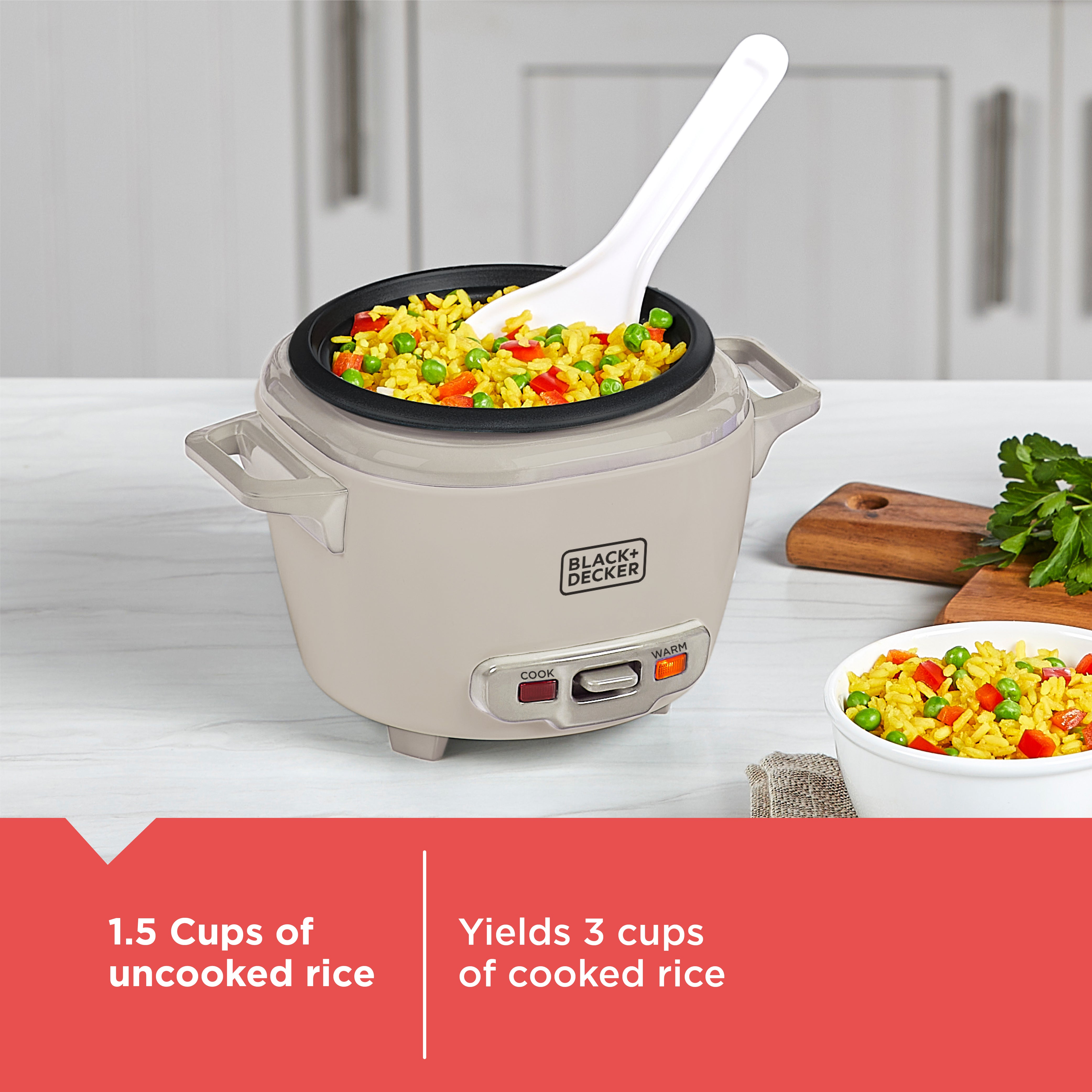 Black & Decker rice cooker with cooked rice and vegetables on a kitchen counter