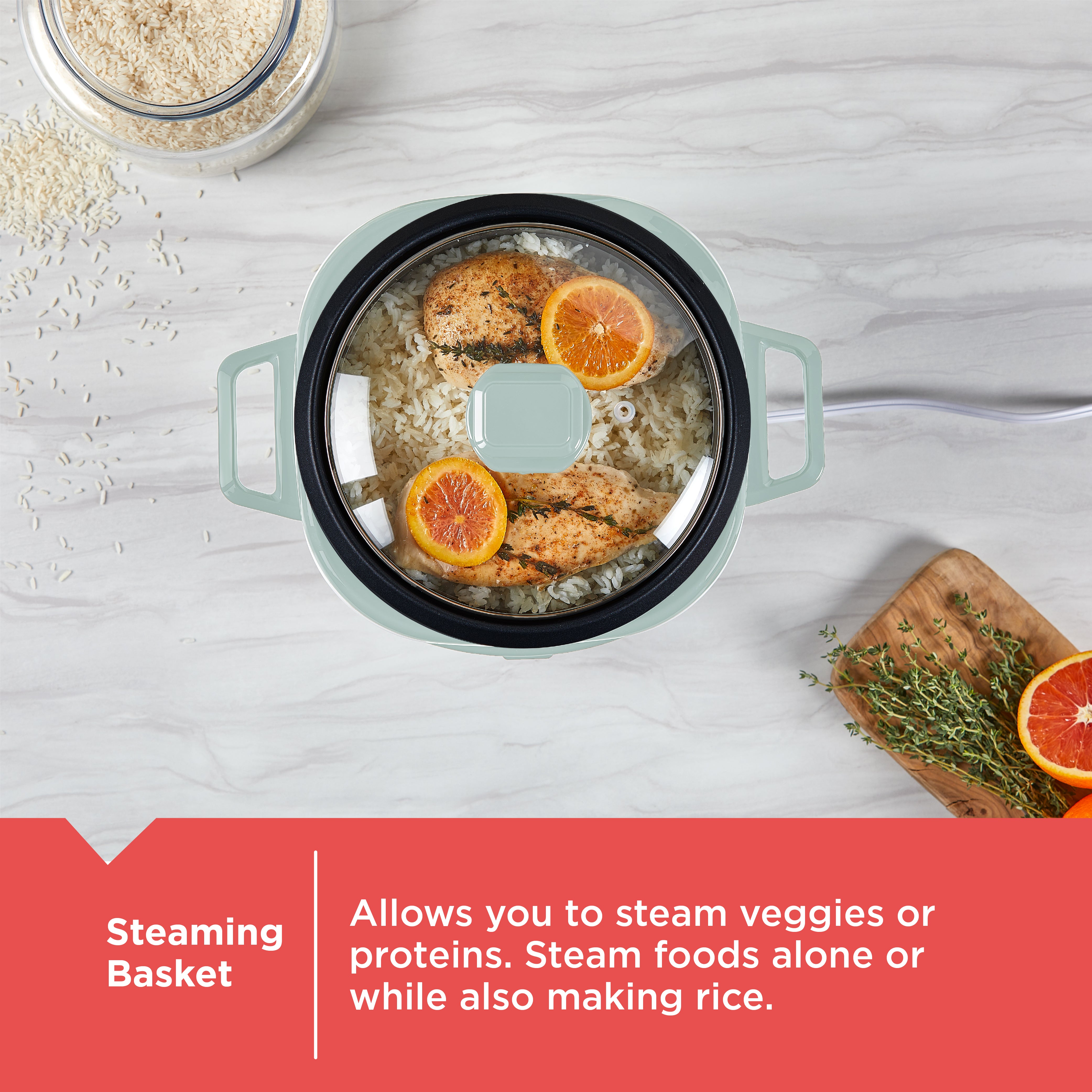 Cooking pot with steaming basket containing food on a light gray surface.