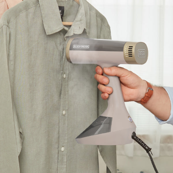 closeup of person steaming a shirt