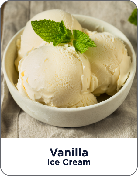 Bowl of vanilla ice cream with mint leaves on a wooden surface