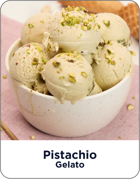 Bowl of pistachio gelato with garnish on a pink background