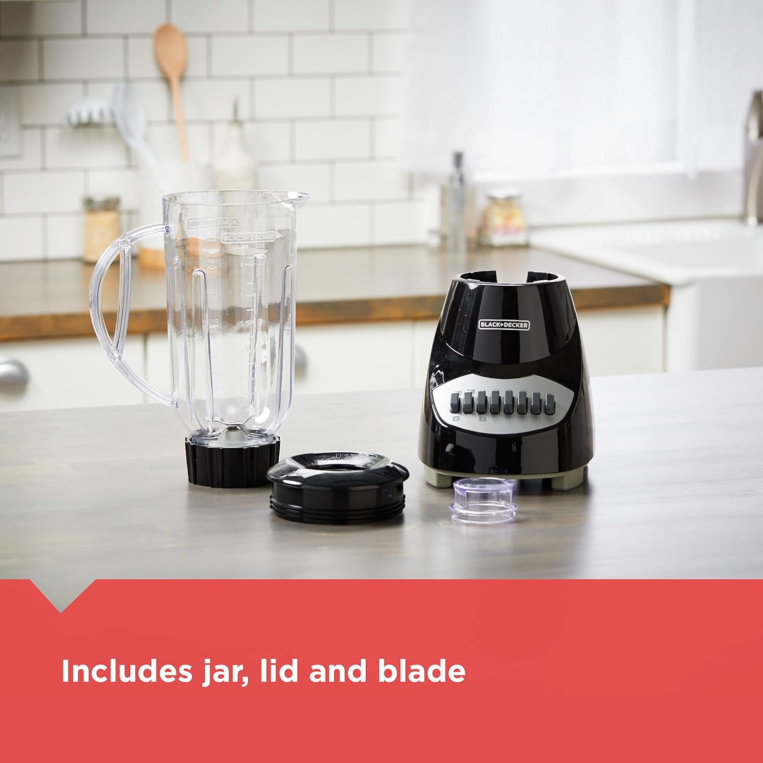 Black blender with jar, lid, and blade on a kitchen counter