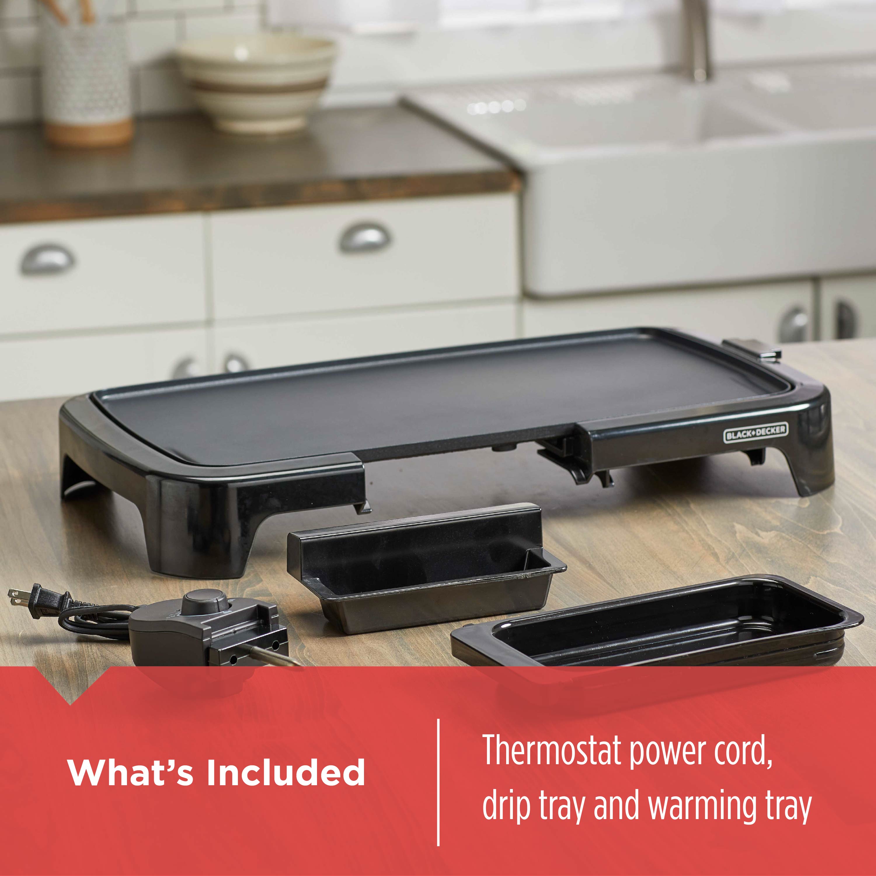 Black electric griddle with accessories on a kitchen counter, featuring 'Black+Decker' branding.