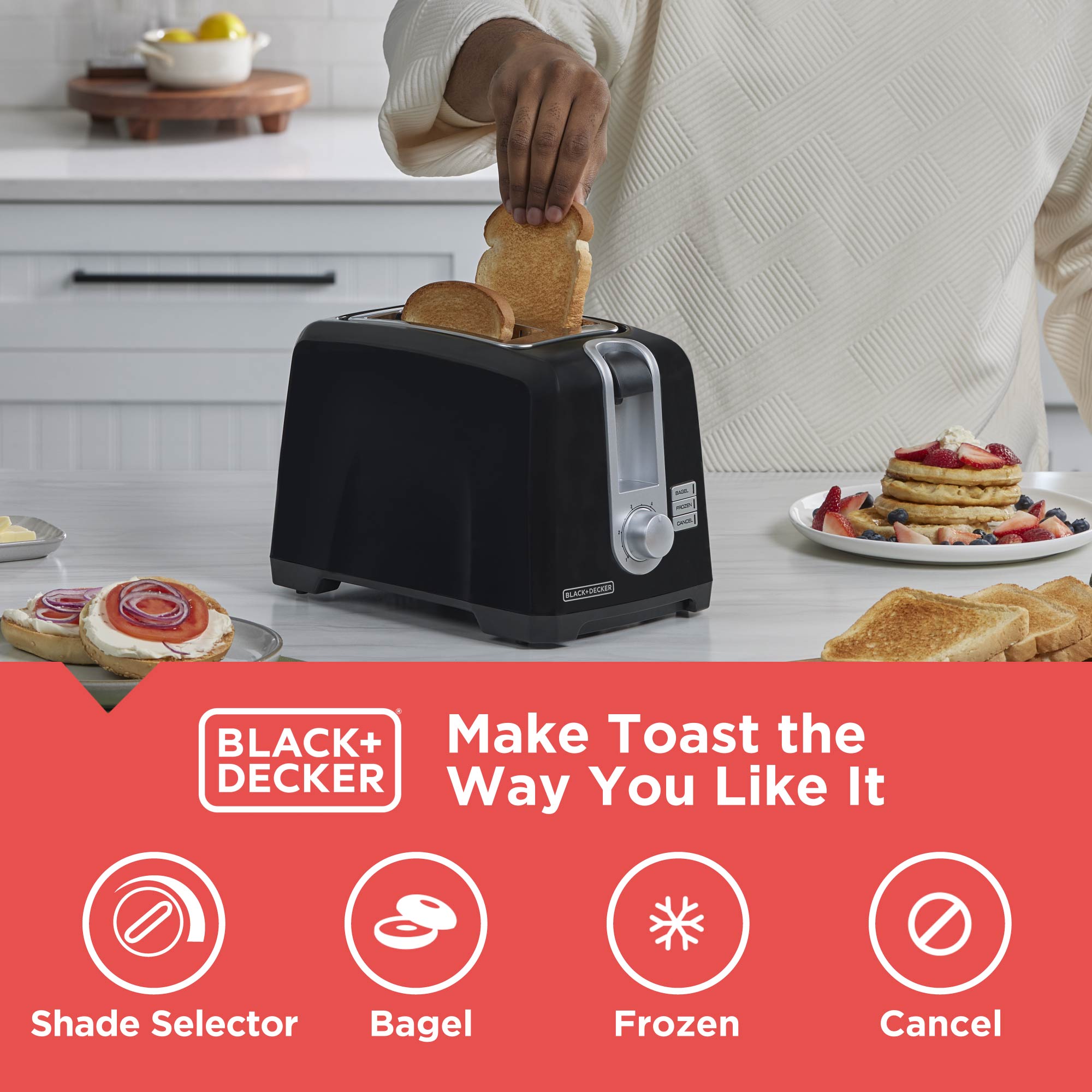 Black+Decker toaster with a person toasting bread, surrounded by breakfast items on a kitchen counter.