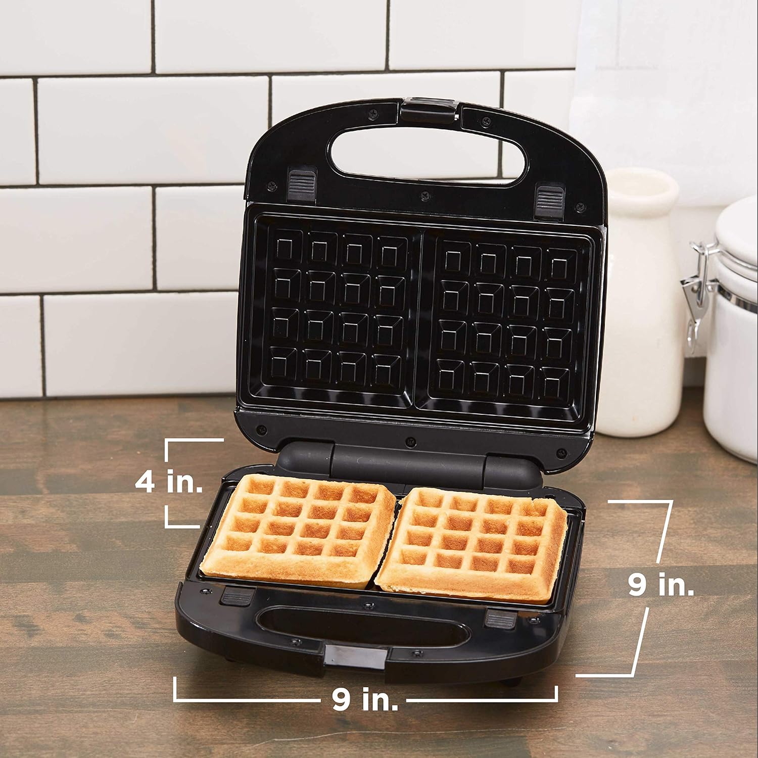 Waffle maker with waffles inside, showing dimensions on a wooden surface.