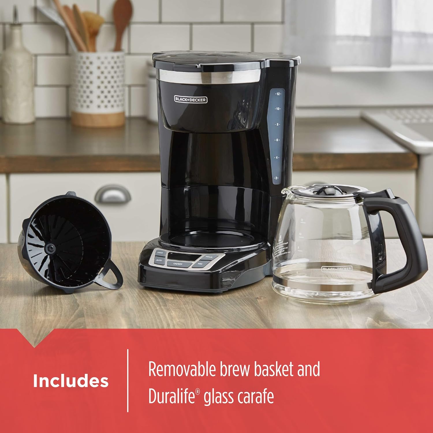 Black coffee maker with removable brew basket and Duralife glass carafe on a kitchen counter.