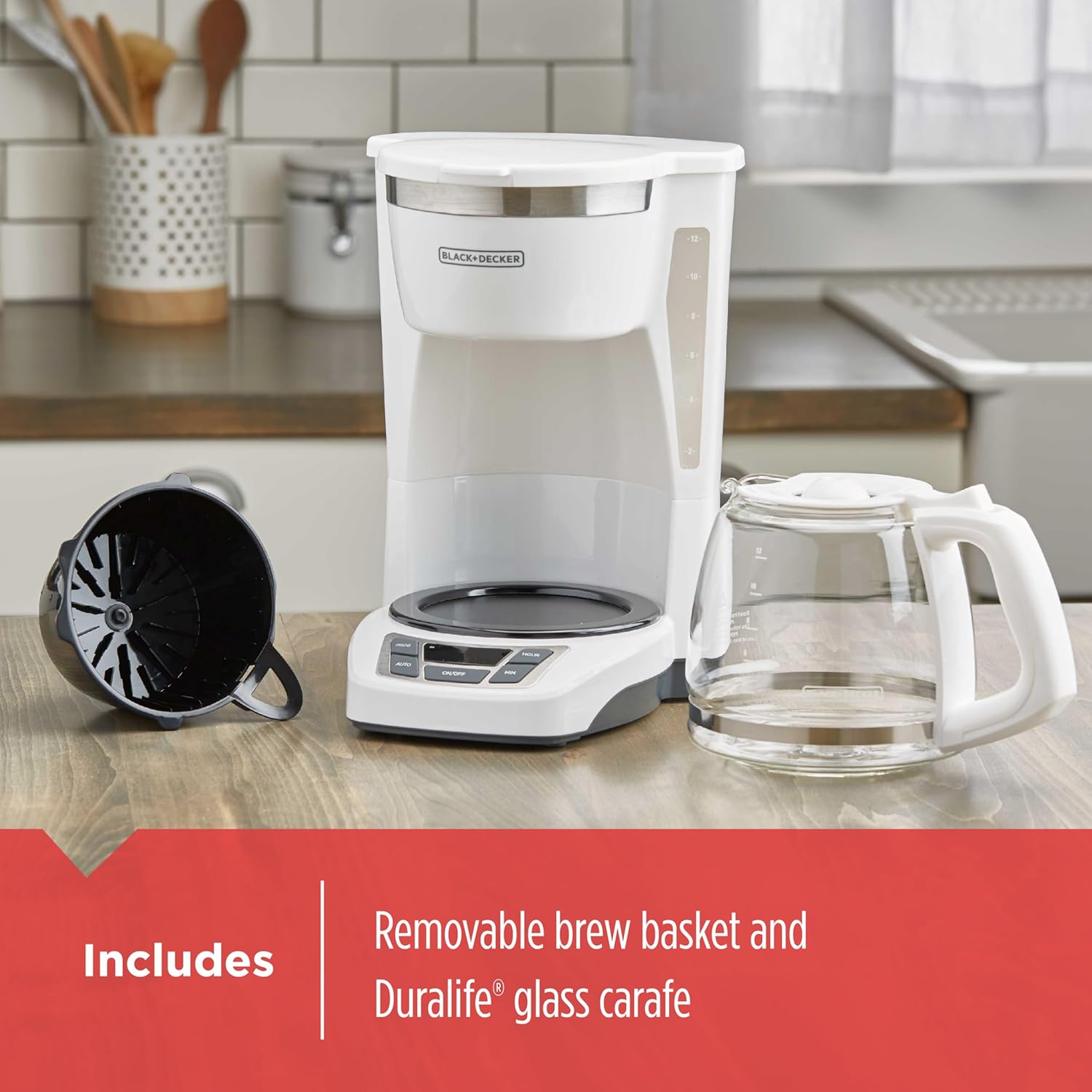 White coffee maker with glass carafe on a kitchen counter, featuring text about included components.
