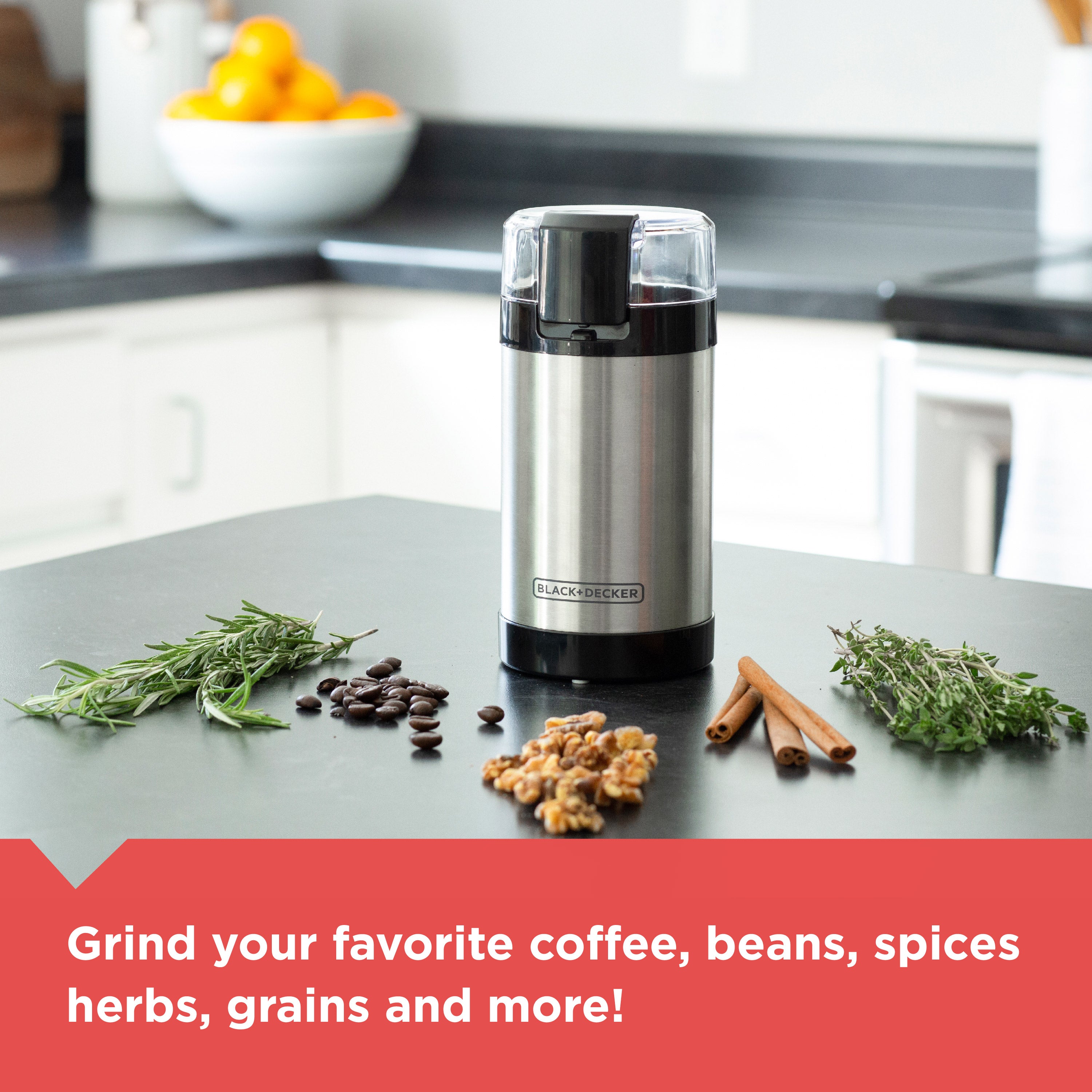 Black+Decker coffee grinder on a kitchen counter with herbs and spices.