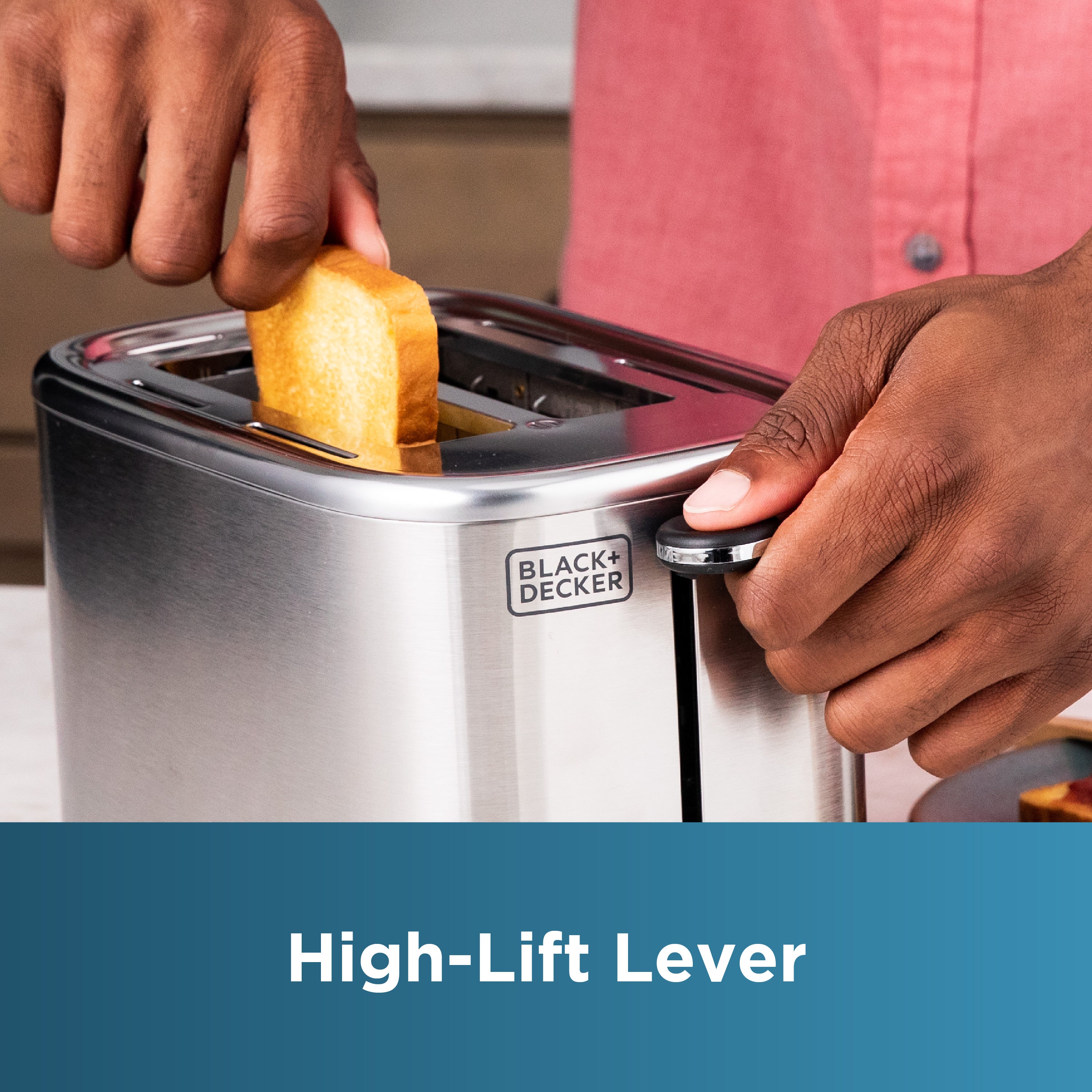 Person using a Black+Decker toaster with a high-lift lever