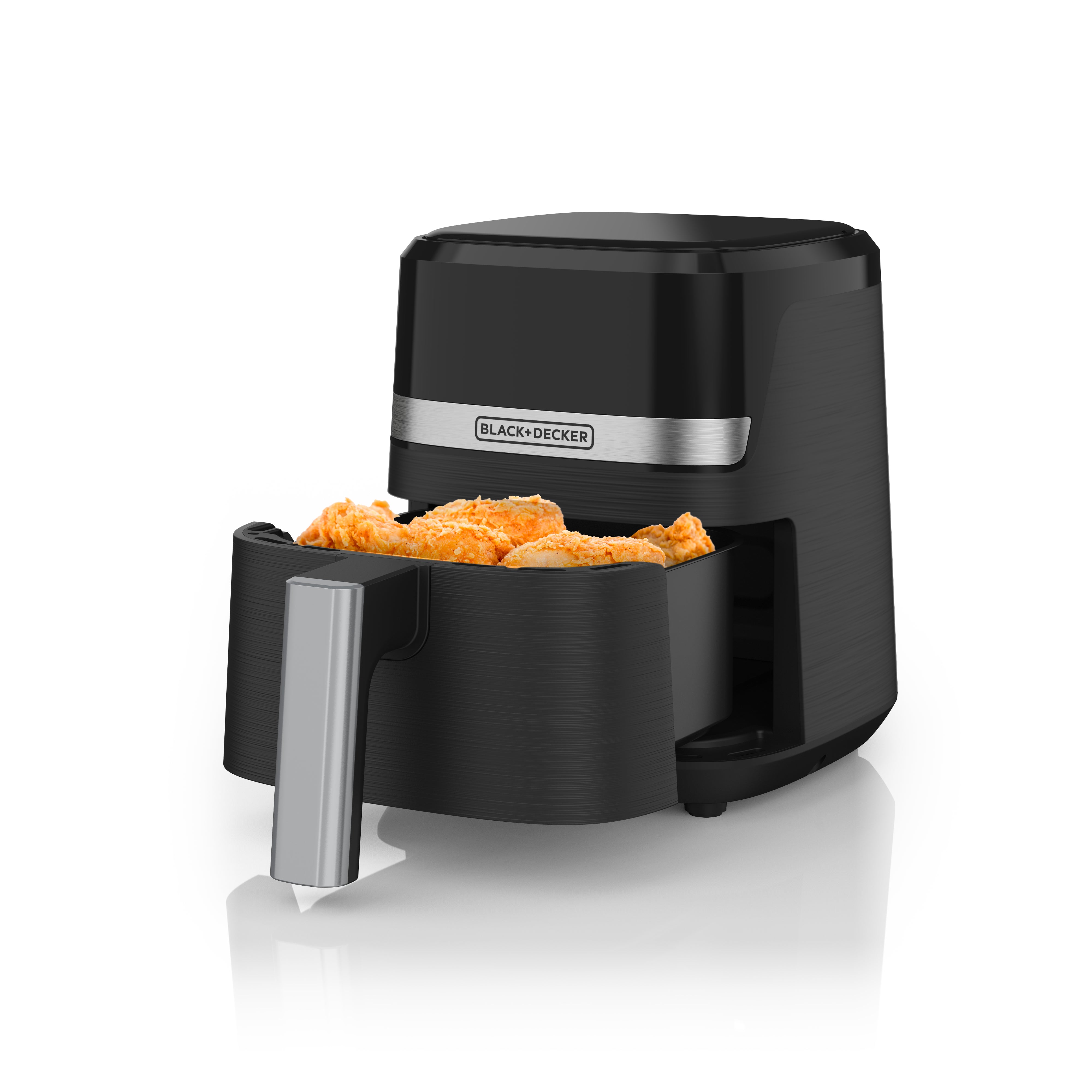 Black air fryer with food inside on a white background