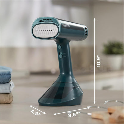 Green handheld steamer with dimensions labeled on a blurred background