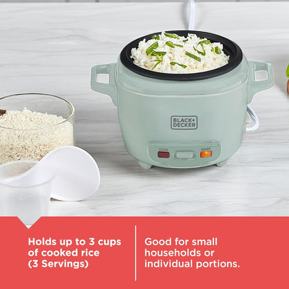 Green rice cooker with cooked rice and peas on a white surface, featuring Black+Decker branding.