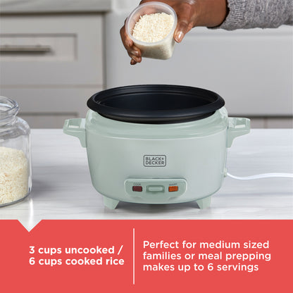 Green rice cooker with a hand adding rice, kitchen setting