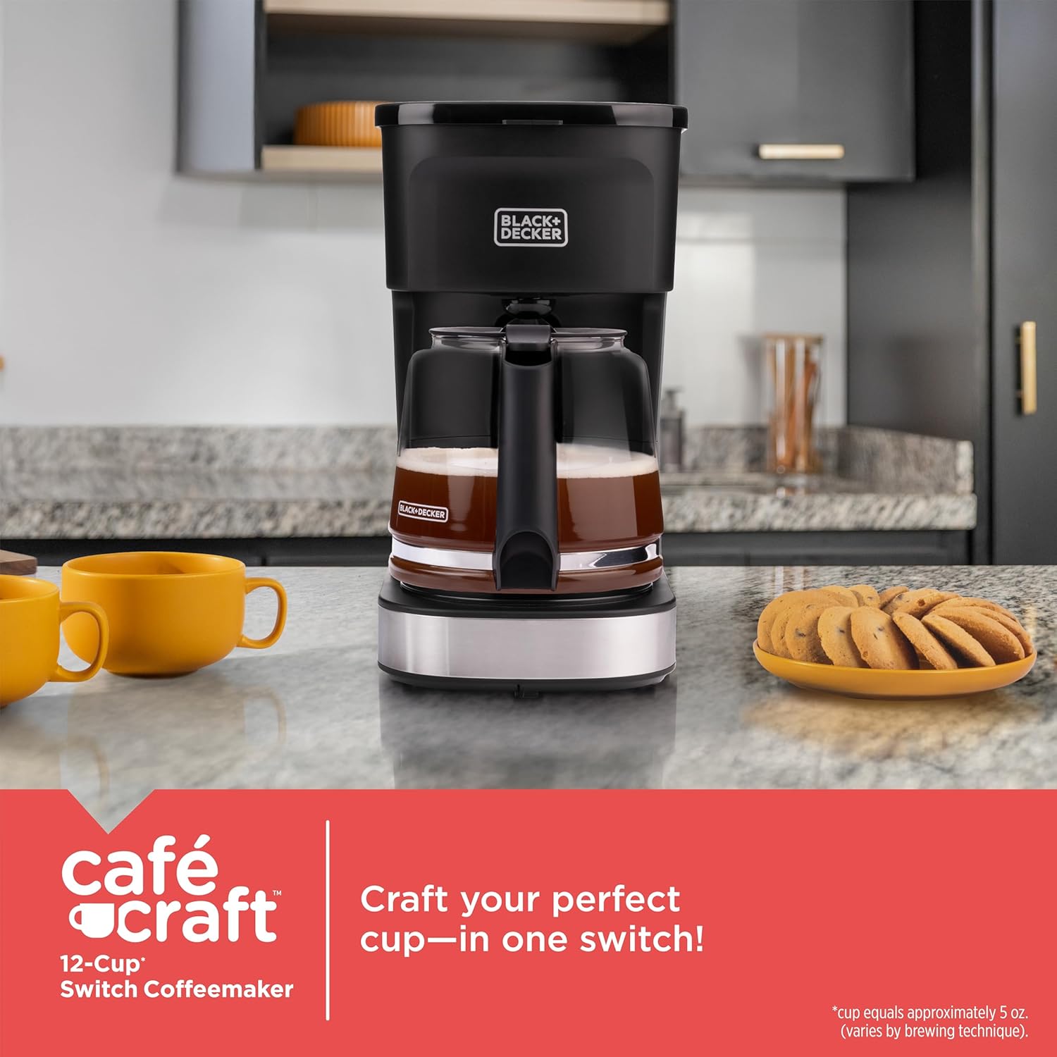 Black & Decker coffee maker on a kitchen counter with yellow mugs and cookies.