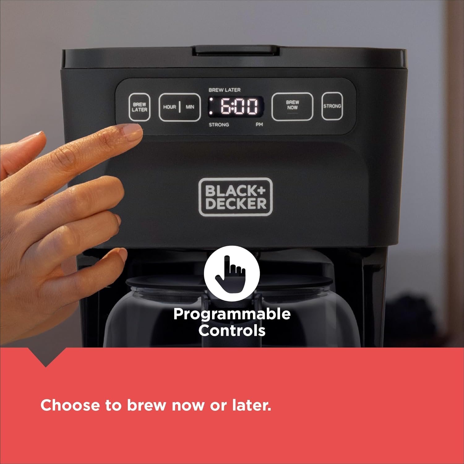 Black+Decker coffee maker with programmable controls and a hand pressing a button.