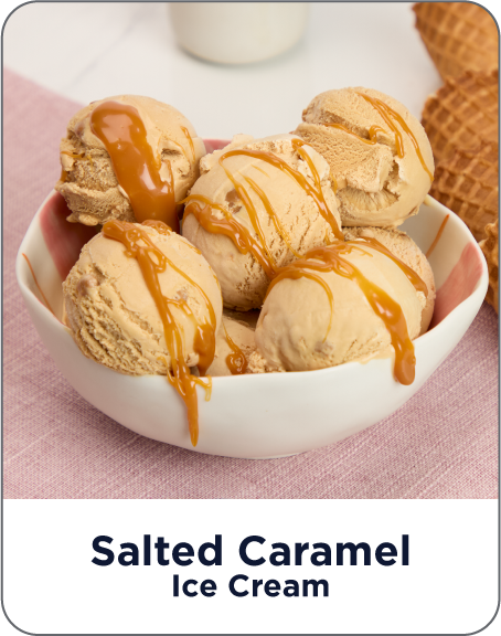 Bowl of salted caramel ice cream with waffle cones on a pink background