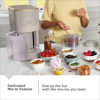 Kitchen scene with a food processor and various mix-ins on a counter.
