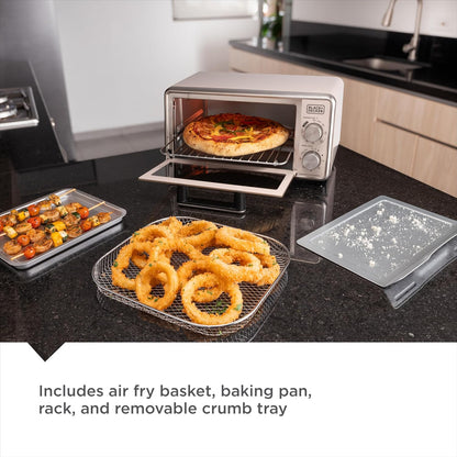 Toaster oven with pizza inside on counter with kabobs on tray and onion rings on tray and crumb tray 