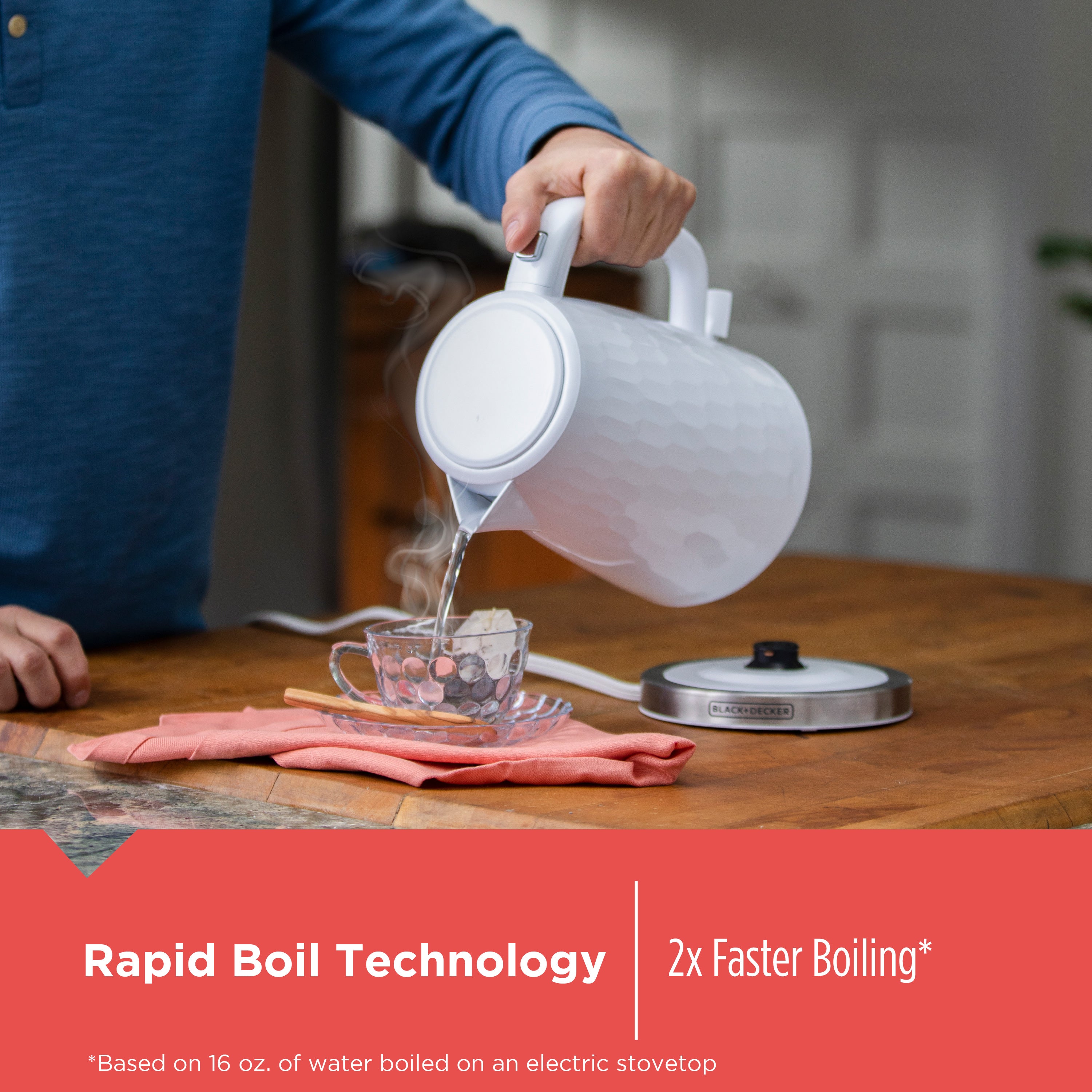 Person using a white electric kettle on a wooden countertop with text about rapid boil technology.
