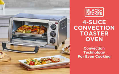 Black+Decker 4-slice convection toaster oven with food inside on a wooden countertop.