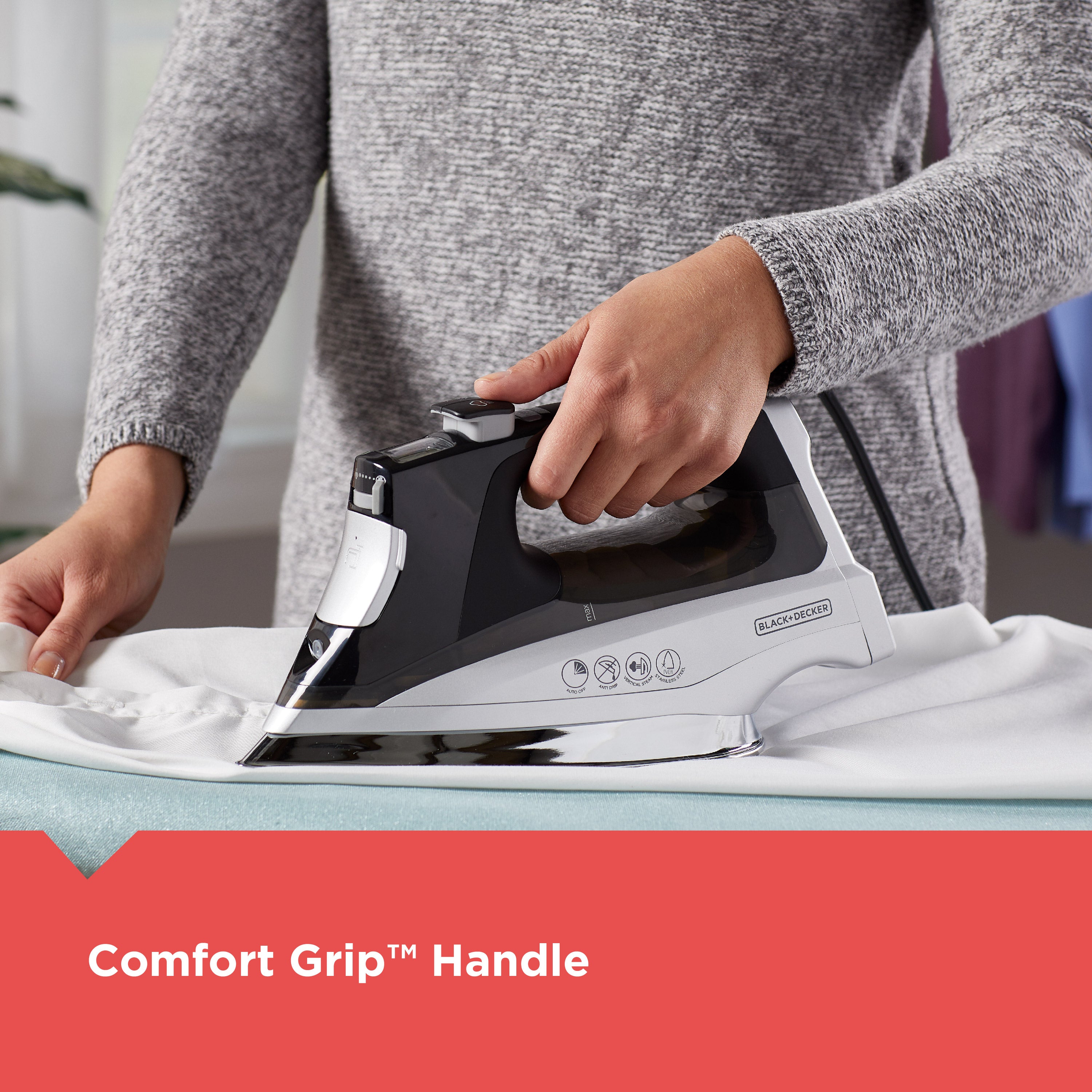 Person ironing a shirt with a Black+Decker iron, emphasizing the comfort grip handle.