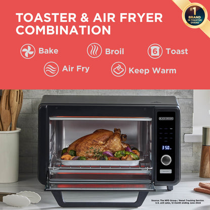 Toaster and air fryer combination with a roasted chicken inside, on a kitchen counter.