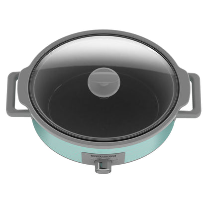Turquoise slow cooker with glass lid on a white background