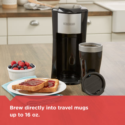 Black and Decker coffee maker with a travel mug on a kitchen counter, surrounded by toast and berries.