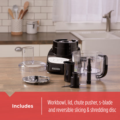 Kitchen blender set on a kitchen counter with components displayed.