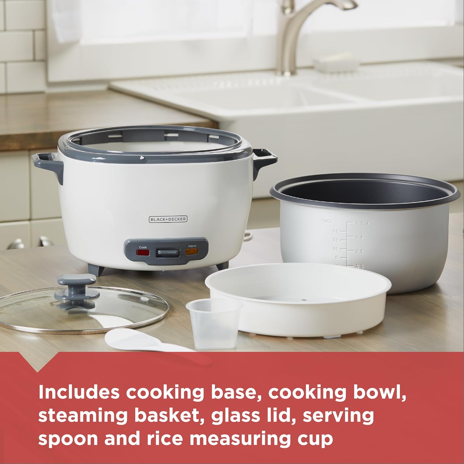 White rice cooker with accessories on a kitchen counter