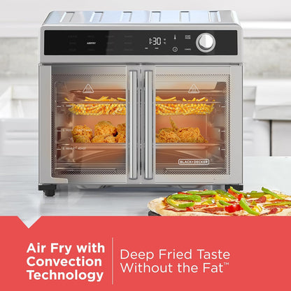 Black+Decker air fryer with food items inside, displayed on a white surface.