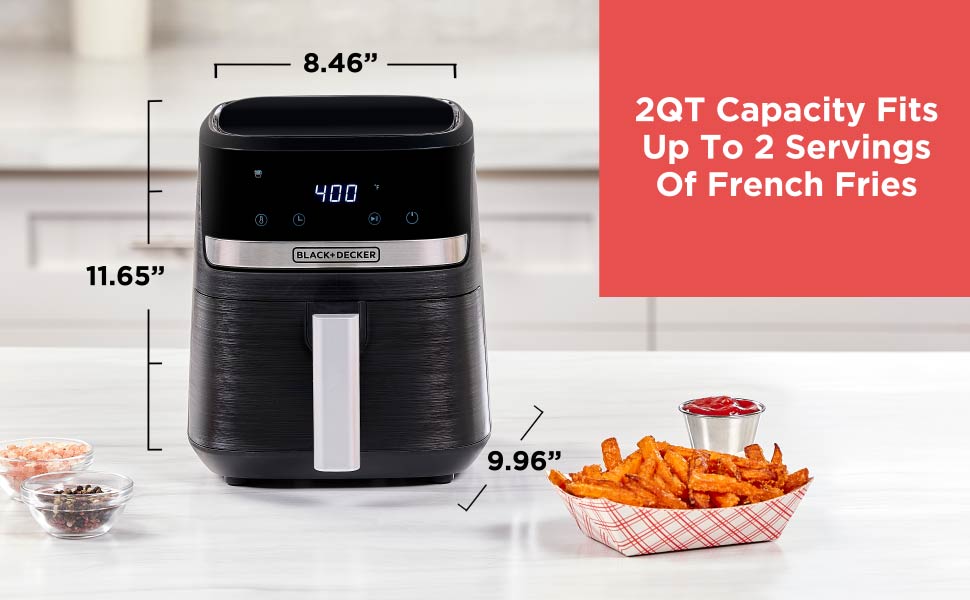 Black air fryer with dimensions and serving capacity information on a kitchen counter.