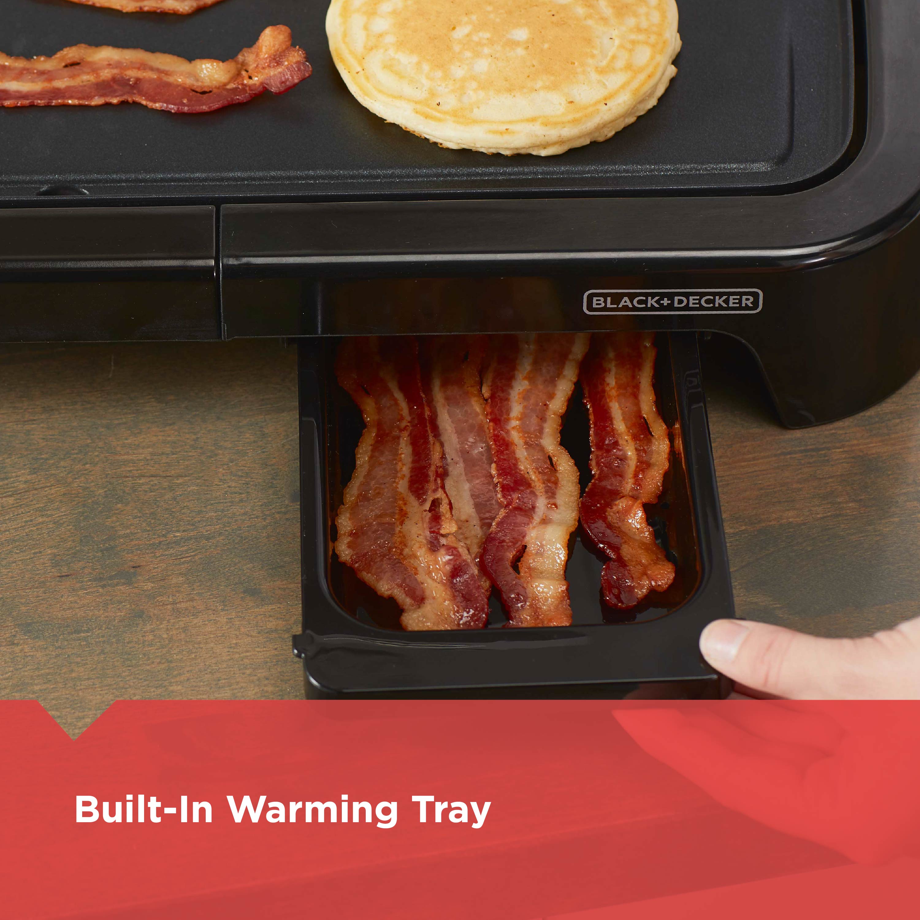 Black and Decker appliance with bacon and pancakes on a warming tray