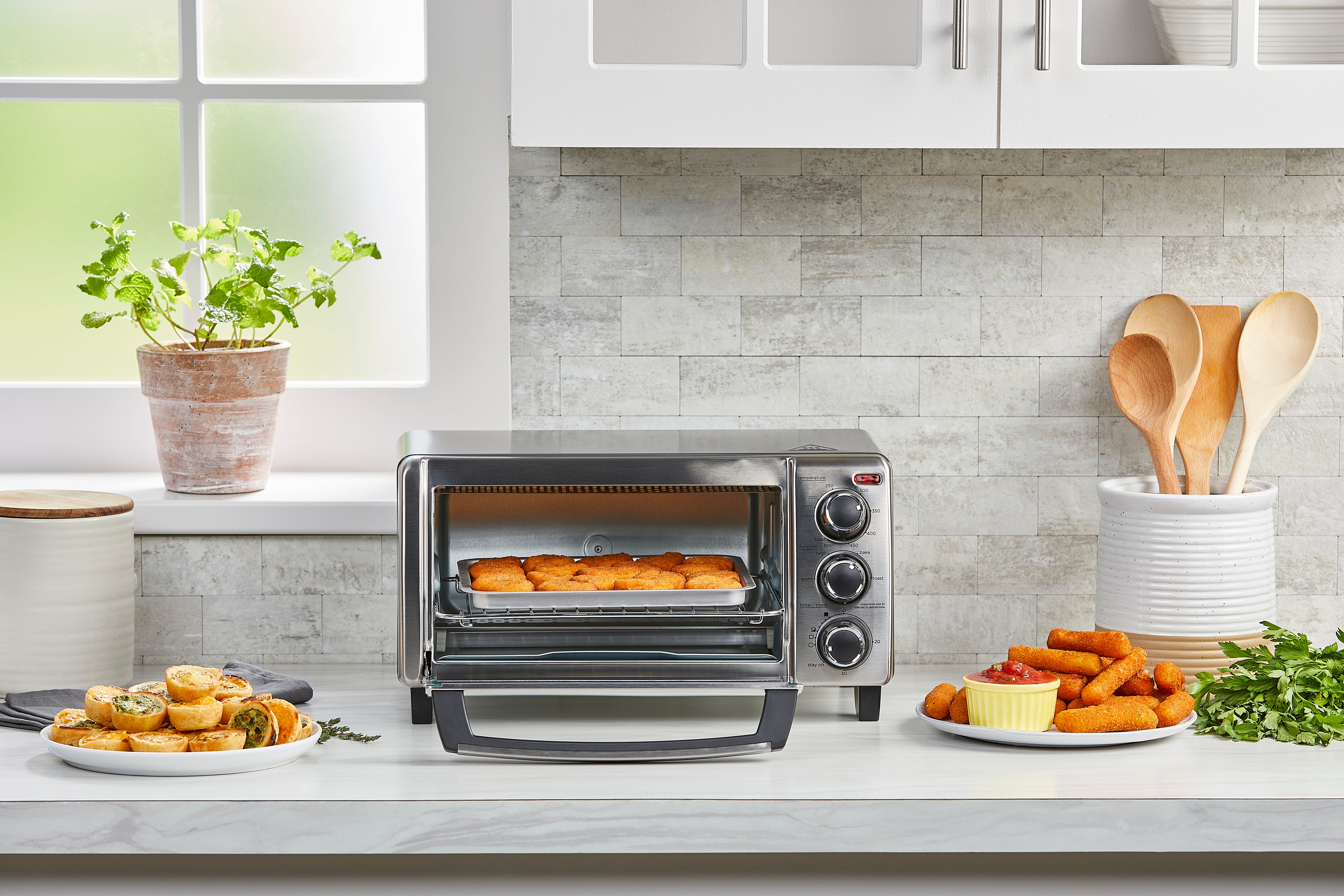 Toaster oven on a kitchen counter with food items around