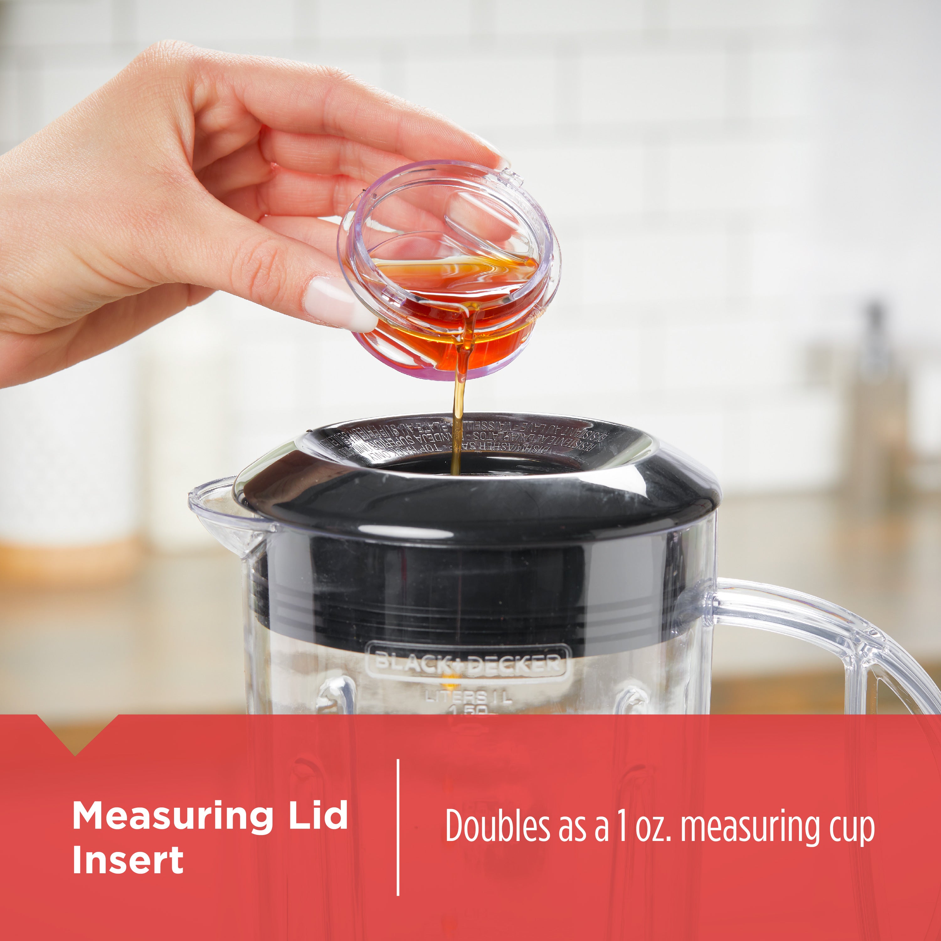 Hand pouring liquid into a Black & Decker coffee maker with a measuring lid insert.