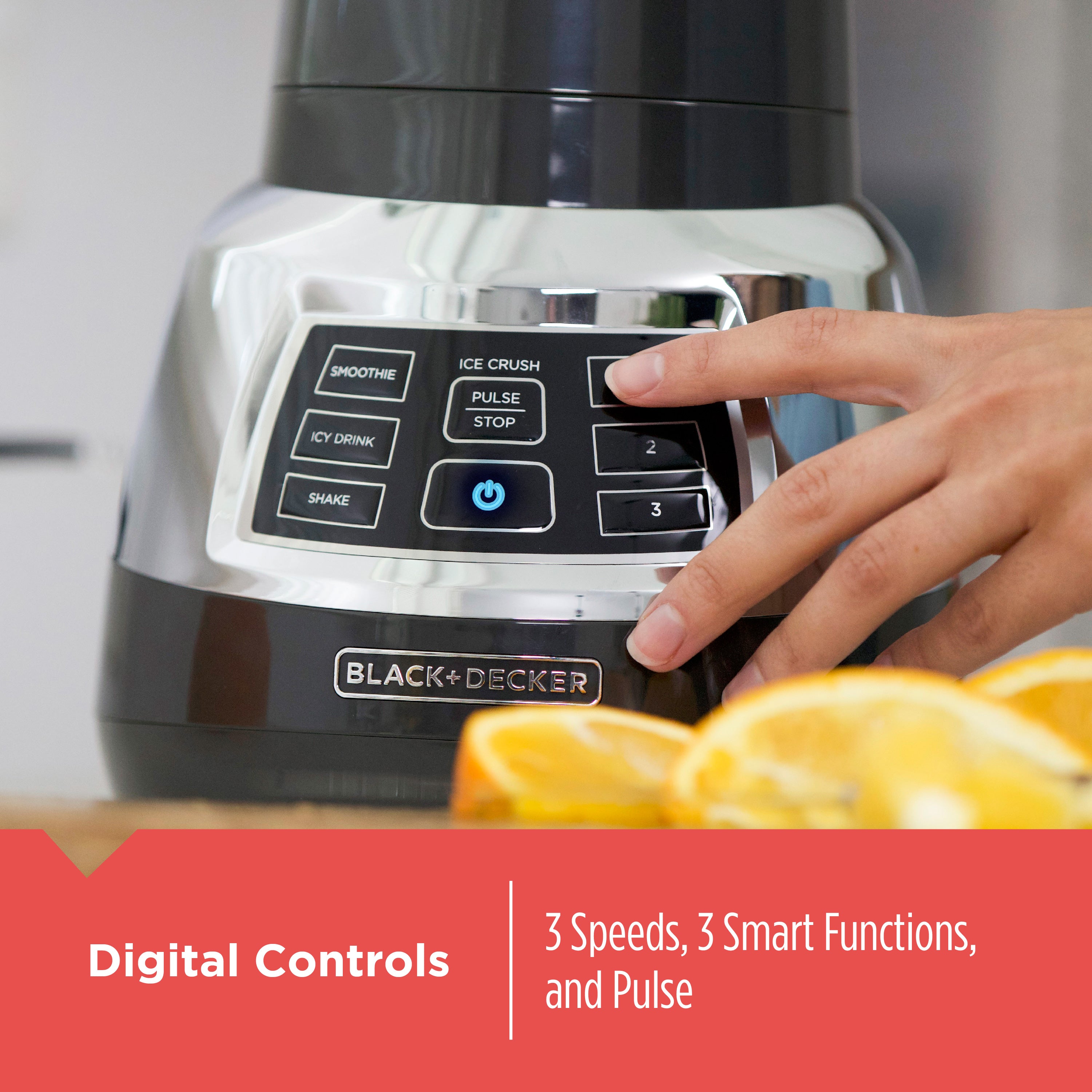 Black+Decker blender with digital controls and a hand pressing a button, surrounded by oranges.