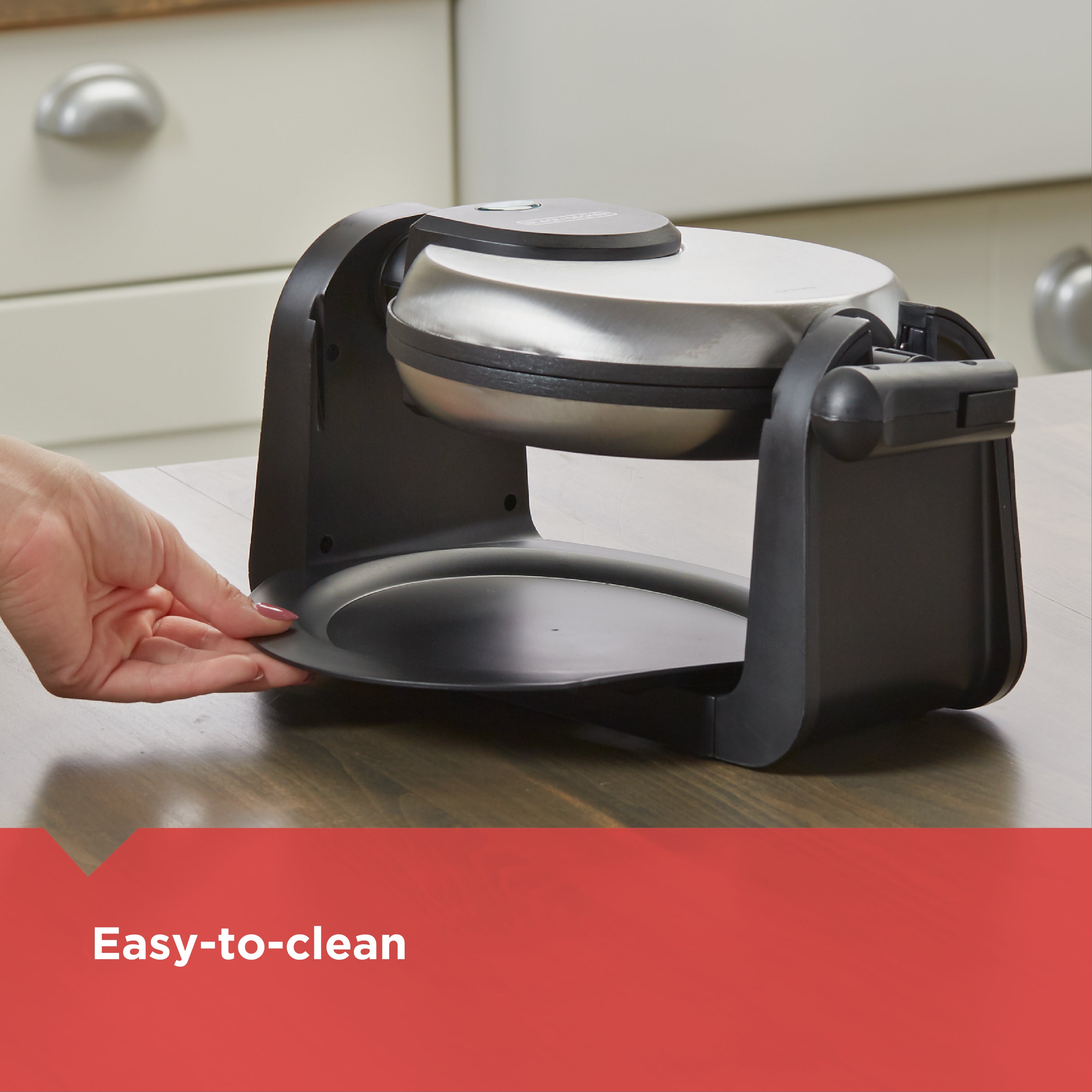 Waffle maker on a kitchen counter with a hand opening it, labeled 'Easy-to-clean'.