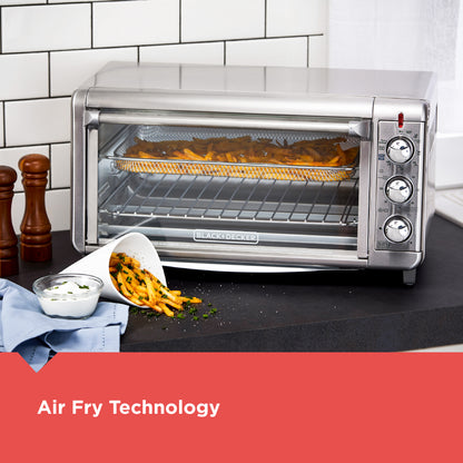 Black+Decker toaster oven with food inside on a kitchen counter, featuring air fry technology.