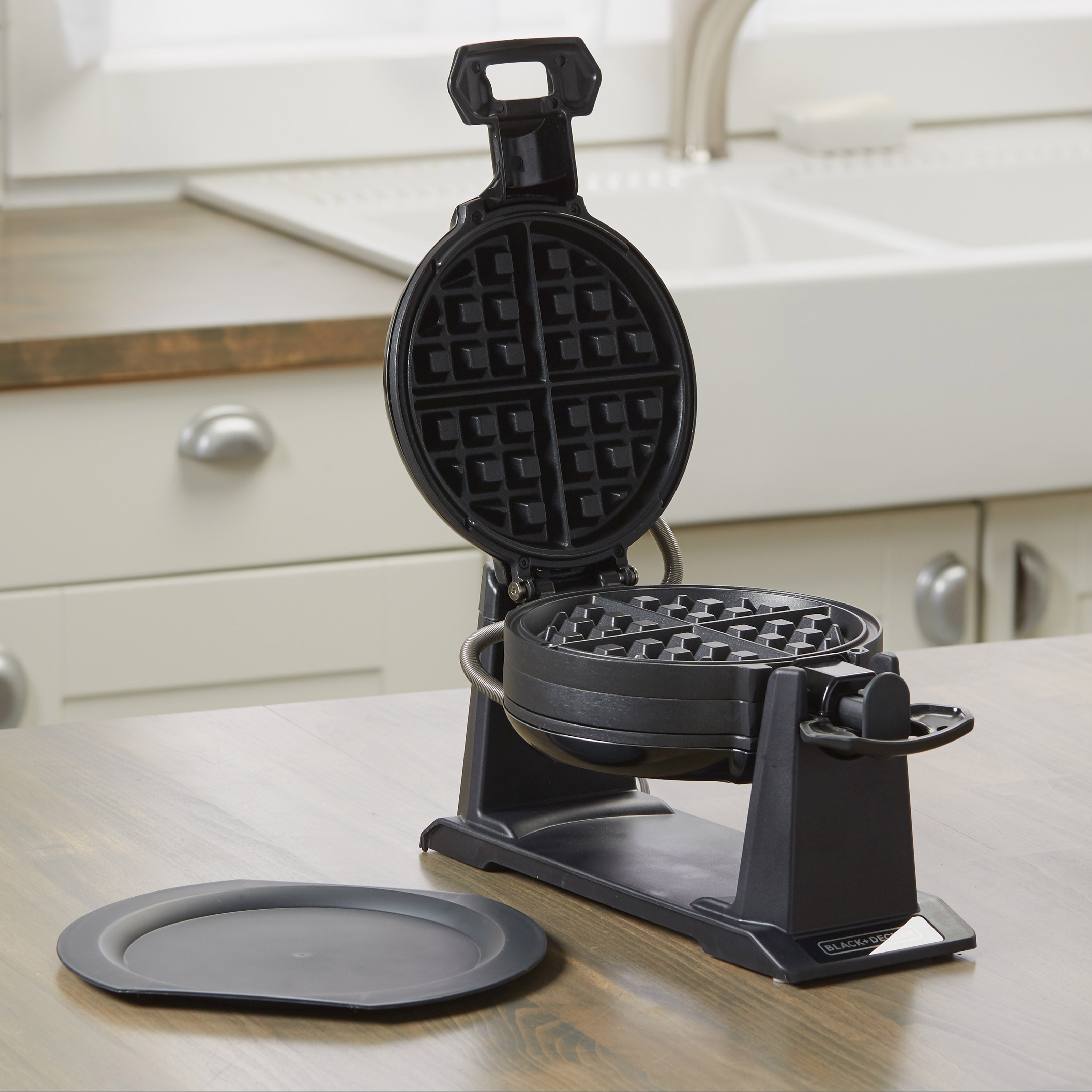 Black waffle maker on a kitchen counter