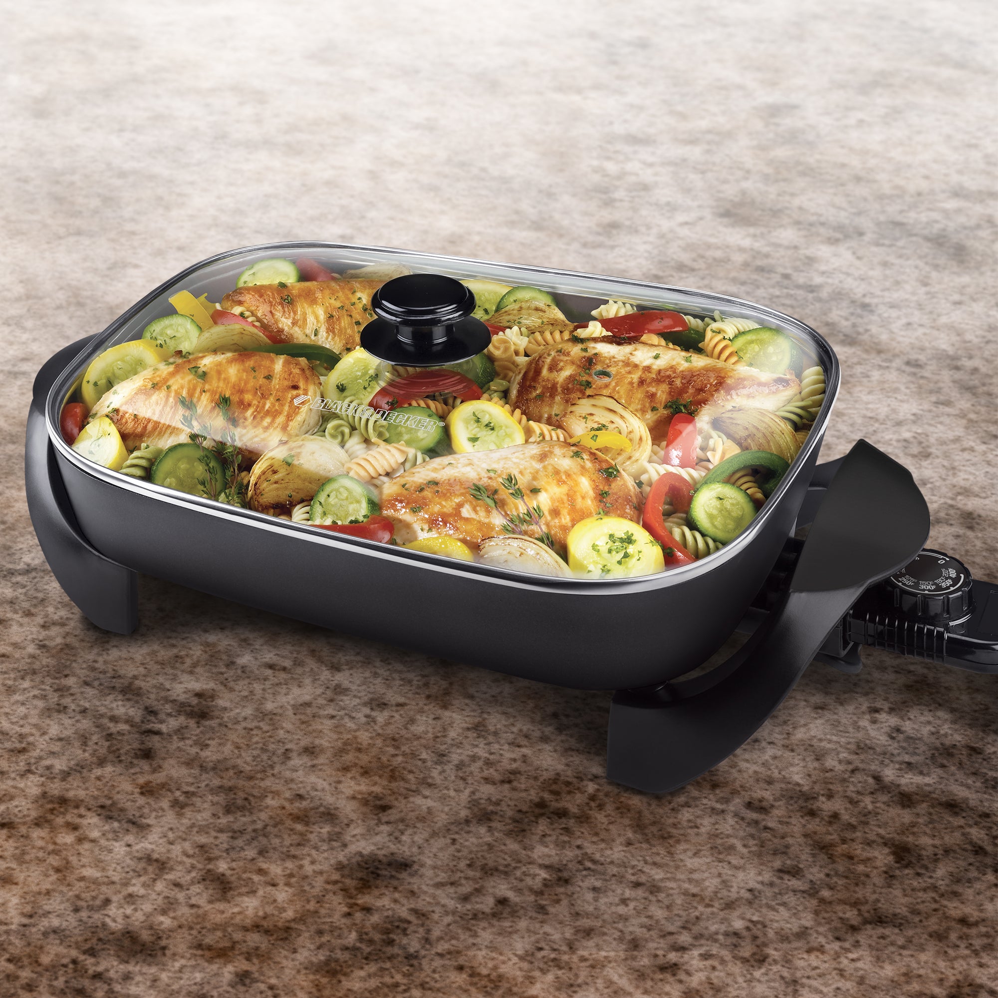 Electric skillet with food on a brown surface